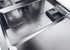 A close-up view of the interior of a dishwasher, showing the detergent dispenser and a 'MAX' fill line. Voir les images du produit