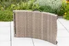 A folded wicker garden lounger is placed on a paved patio with plants in the background. Produktbild-Vorschau