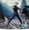 A figurine of Satoru Gojo from Jujutsu Kaisen standing on a pile of debris with a blurred background of traditional Japanese architecture and mountains. Produktbild-Vorschau