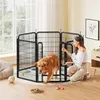 A woman is interacting with a dog inside a black metal playpen in a room. Produktbild-Vorschau