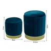 Two blue velvet ottomans with gold bases are shown side-by-side, with dimensions indicated by measurement lines and text. Náhľad obrázku produktu