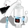A close-up of a white electric hot water tap with a digital display showing '49', with water flowing from the spout. A black sink is visible in the background. Náhled obrázku produktu