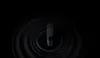 A black cylindrical object is centered on a dark background with concentric ripple-like patterns emanating from it. Náhľad obrázku produktu