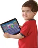 A young boy is holding and looking at a tablet. Podgląd zdjęcia produktu