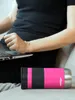 A person is using a laptop while a pink Contigo travel mug rests on a couch next to them. Anteprima dell’immagine prodotto