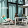 A couple relaxing on a patio with a table and chairs. Produktbild-Vorschau