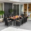 An outdoor patio dining set with a table and chairs, set on a wooden deck next to a modern house. Náhľad obrázku produktu
