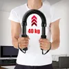 A person holding a resistance band exercise device indoors. Podgląd zdjęcia produktu