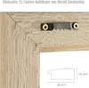Close-up of the back of a picture frame showing mounting hardware and a diagram of the frame's profile. Produktbild-Vorschau