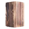 A close-up view of a wooden bird feeder with a burnt wood finish. Podgląd zdjęcia produktu