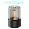 A product shot of a black and clear aroma diffuser with a gold element inside, set against a white background. There are stylized green leaves and blue swirls above the diffuser, suggesting air circulation or fragrance diffusion. Podgląd zdjęcia produktu