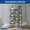 A multi-tiered plant stand filled with various potted plants, set against a light gray wall and a patterned rug. Podgląd zdjęcia produktu
