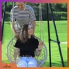 A couple enjoying a swing chair outdoors. Voir les images du produit