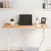 A wooden tabletop with a laptop, a plant, and office supplies on a white wall background. Produktbild-Vorschau