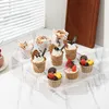 A display of cupcakes on a tiered acrylic stand. Produktbild-Vorschau