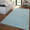 A light blue rug is placed on a wooden floor in front of a white sofa in a living room. Produktbild-Vorschau