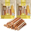 Two bags of dog treats are shown above a pile of the treats themselves. Produktbild-Vorschau