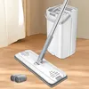 A mop and bucket set on a wooden floor with a curtain in the background. Produktbild-Vorschau