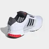 A side view of a white Adidas shoe with black stripes and red accents on the sole. Podgląd zdjęcia produktu
