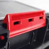A close-up view of a red plastic latch on a black storage container. Produktbild-Vorschau