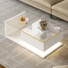 A modern white coffee table with LED lighting is placed on a grey carpet next to a beige sofa. Podgląd zdjęcia produktu