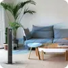 A modern living room with a couch, coffee table, plants, and a tower fan. Podgląd zdjęcia produktu