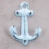 A light blue anchor hook against a textured neutral background. Produktbild-Vorschau