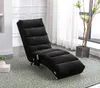 A black chaise lounge chair is placed on a patterned rug in a room with a window and curtains in the background. Náhled obrázku produktu
