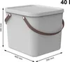 A light gray storage bin with brown handles and a lid, shown with dimensions indicated. Produktbild-Vorschau