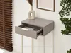 A close-up of a narrow console table with an open drawer, placed against a wall with blinds and a framed picture. Produktbild-Vorschau