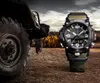 A G-SHOCK Mudmaster watch is placed next to a large off-road vehicle tire in a rugged, outdoor setting. Podgląd zdjęcia produktu