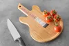 A wooden cutting board shaped like a guitar, with tomatoes and a knife on it. Náhľad obrázku produktu