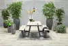 An outdoor picnic set with benches, surrounded by potted plants and decorative lanterns, under a hanging heater. Produktbild-Vorschau