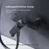 A close-up shot of a black bathroom faucet mounted on a textured gray wall. Produktbild-Vorschau