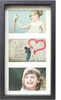 A black multi-photo frame with a white mat and three inserted photos. The top photo shows a young girl taking a selfie with a vintage camera. The middle photo shows a person painting a red heart on a wall. The bottom photo is a close-up of a smiling young  Náhľad obrázku produktu