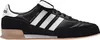 A side view of a black Adidas sneaker with white stripes and tan sole. Anteprima dell’immagine prodotto
