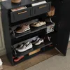 A dark gray shoe cabinet with multiple shelves and drawers, displaying various shoes and a small bag. Podgląd zdjęcia produktu