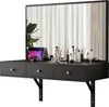 A black floating vanity desk with a large mirror and various makeup items on top. Voir les images du produit