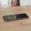 A smartphone is placed on a wooden surface. Produktbild-Vorschau