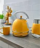 A kitchen counter with a yellow kettle, mug, and cup holder. Produktbild-Vorschau