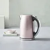 A pink Cuisinart electric kettle is displayed on a light gray surface with a small pink bowl and spoon to the left. Voir les images du produit