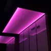Modern building exterior at night with pink LED lighting. Podgląd zdjęcia produktu