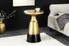 A gold and black accent table is placed next to a sofa in a living room setting. Produktbild-Vorschau