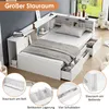 A white bed frame with integrated storage and shelving, shown in a bedroom setting with a window view. Produktbild-Vorschau