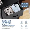 A close-up of an open drawer in a chest of drawers, revealing folded clothes. Text and icons are overlaid on the image, describing storage features and use cases. Voir les images du produit