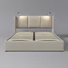 A beige upholstered bed frame with a slatted mattress base and two integrated reading lights. Náhled obrázku produktu
