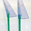 Close-up view of two shower door seals attached to glass panels. Produktbild-Vorschau