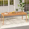 An outdoor dining table set on a patio with a rug and plants. Anteprima dell’immagine prodotto