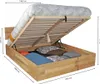 A wooden bed frame with the mattress lifted to reveal storage space underneath, showing pillows and bedding. Produktbild-Vorschau