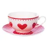 A teacup and saucer set with a heart pattern. Anteprima dell’immagine prodotto